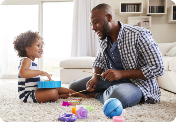 an adult man smiling with a female kid